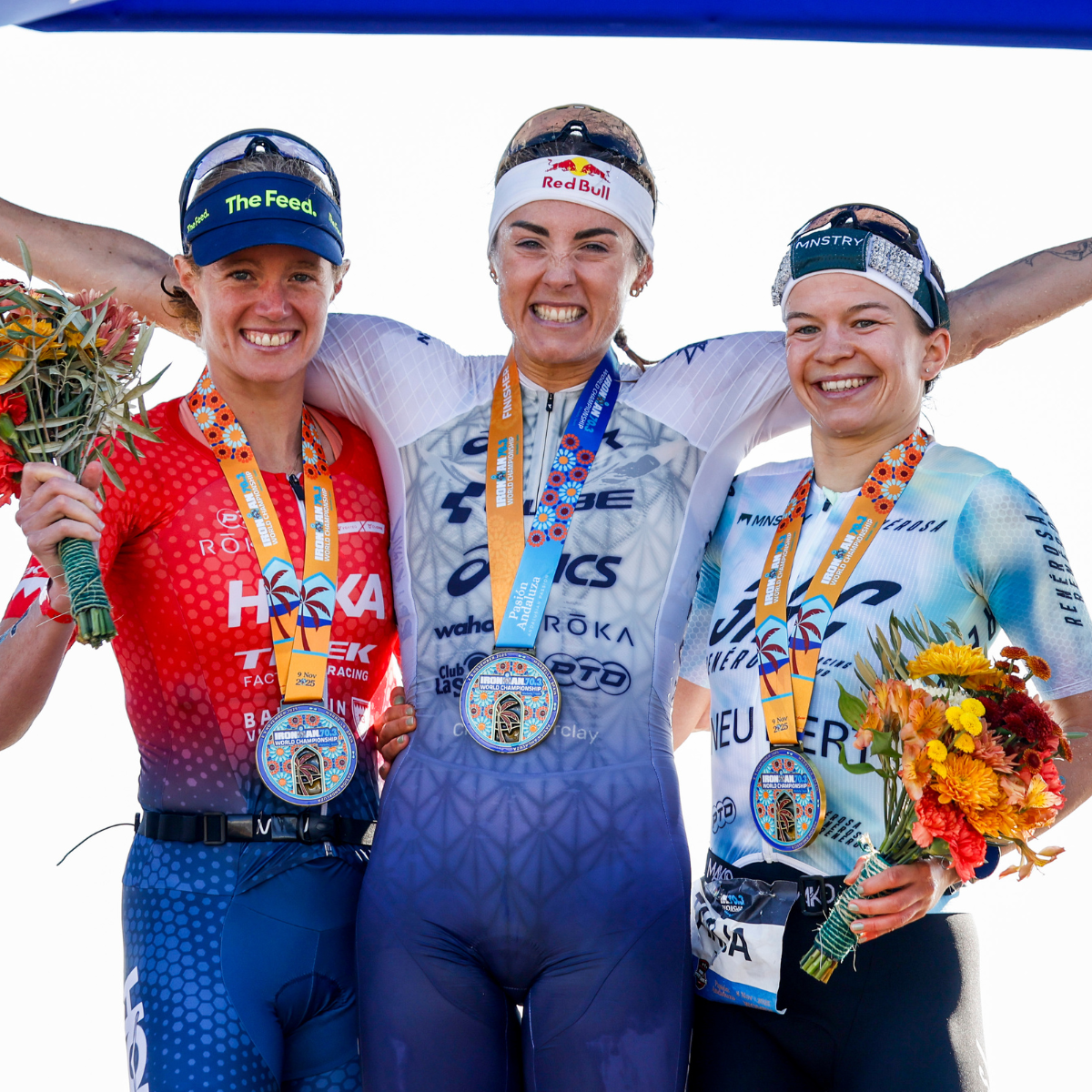 Lucy Charles-Barclay and Taylor Knibb stand and smile 2025 on the Ironman 70.3 World Championship podium