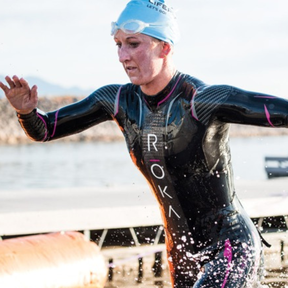 Meredith Kessler exits the water in a ROKA wetsuit